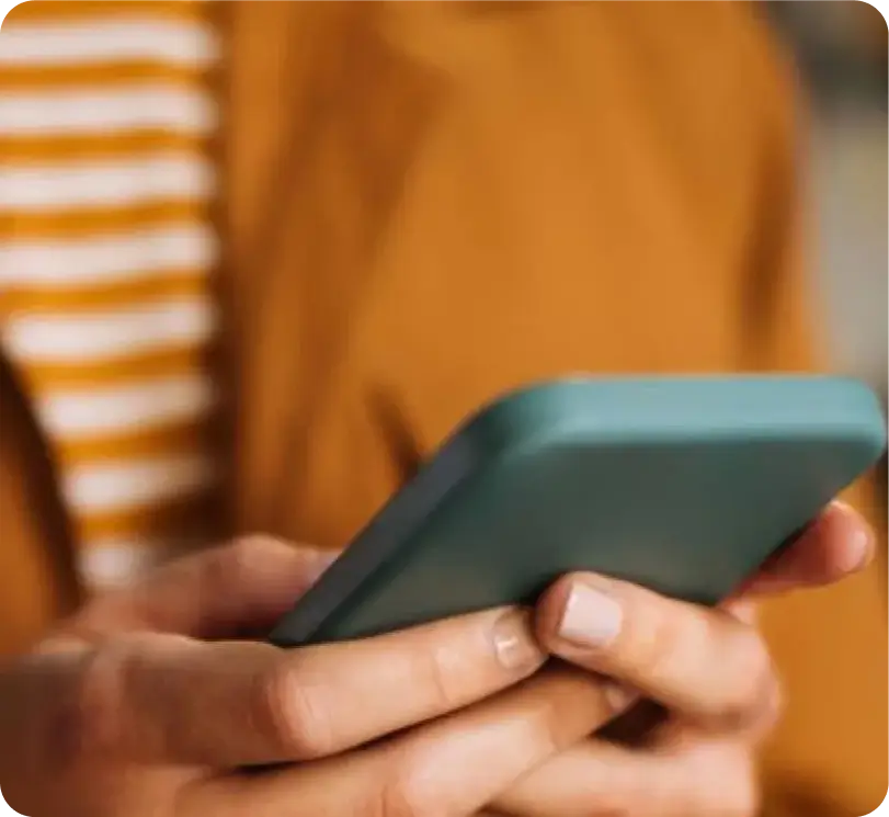 Woman holding and using mobile phone